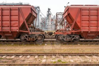 View of grain terminal through the two linked together railway bulk carriages. Rail cars for the transportation of grain.