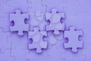 Close up top view shot of purple jigsaw puzzle background
