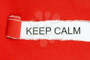 Top view of red torn paper and the text KEEP CALM on a white background. Inspiration, motivation and business concept.
