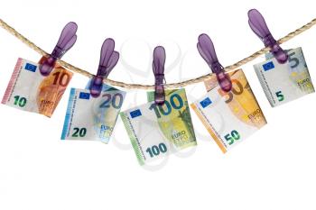 Euro notes on clothesline isolated on white background. Concept of money laundering.