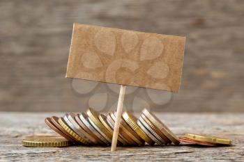 Pile of coins with blank banner for your text