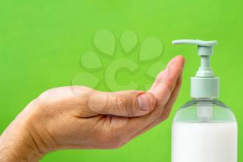 Men hand using wash hand sanitizer gel pump dispenser. 
