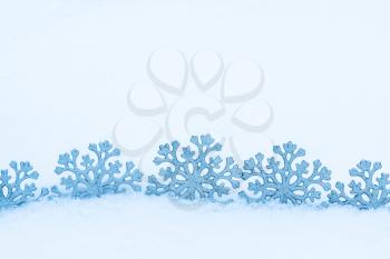 Christmas decoration. Beautiful snowflakes on real snow outdoors. Winter holidays concept