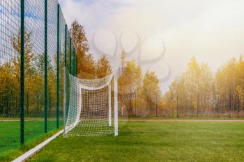 Gate on a soccer field. Football goals on countryside field. Side view.