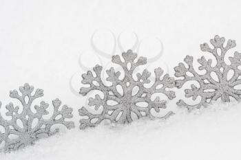 Christmas snowflake shape decorations on real snow outdoors