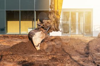 Working excavator bucket. Excavation work.Power shovel moving soil. Digging building foundations. 