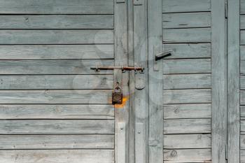 Old grey wooden door of the barn or garage