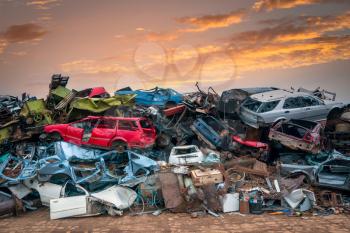 Damaged cars on the junkyard waiting for recycling or destruction
