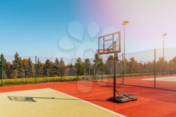 Basketball hoop and court with nature background