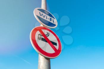 Pole with signs of Wireless Internet Hotspot and Smoke-Free zone