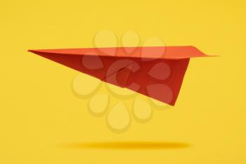 Red paper aircraft fly over yellow background. Travel concept.