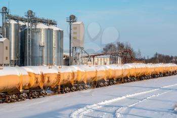 Set of old tanks with oil and fuel transport by rail in winter