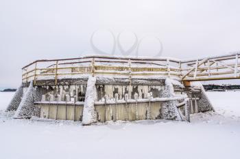 Frozen and snow covered metal dam construction. Extremely Cold Weather.