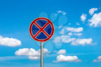 No parking traffic sign on the cloudy sky background.Do not stop traffic sign