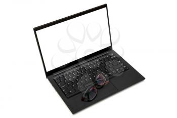 Eyeglasses on black laptop keyboard. Isolated on white background. Copy space.