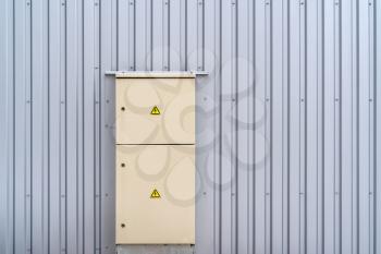 Locked outdoor electric distribution cabinet. Electricity, high voltage, danger zone.