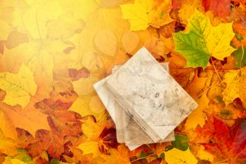 Stack of books with colorful autumn leaves - seasonal relax concept 