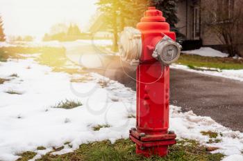 Red fire hydrant in the small town street. Fire hidrant for emergency fire access .