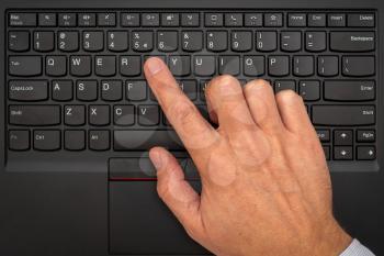 Close-up of the hand are using laptop keyboard. Top view.