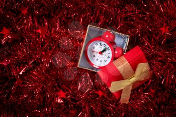 Christmas and New Year holiday composition with gift box and alarm clock .Countdown to midnight. 