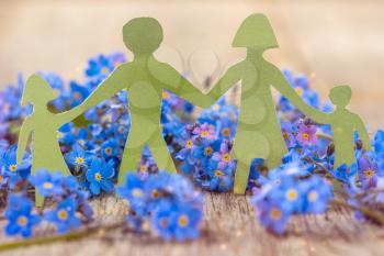 Paper cut of family with flowers background.Family Life Insurance.Protecting family, family concepts. 