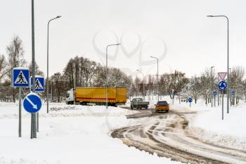 Cars maneuvering in the roundabout after heavy snowfall