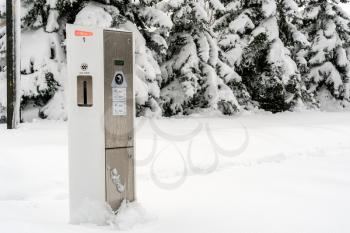 Modern electric car charging station in a snow