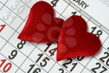 Valentine's day background, February 14 on the calendar with two red hearts 