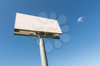Blank billboard or signpost against blue sky, put your own text here