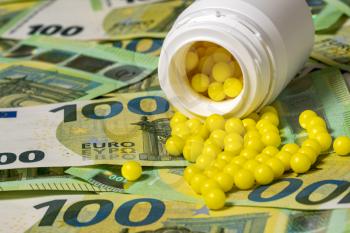 Pills of vitamin C spilled on Euro currency background