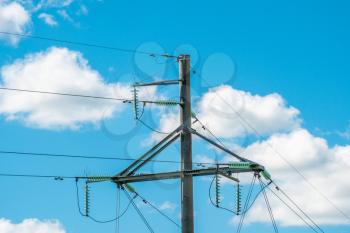 High voltage electricity transmission pylon on the sky background