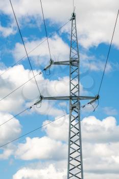 High voltage electricity transmission tower on the sky background