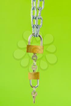 Gold padlocks with keys hanging on the metal chain