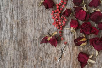 Rosary and dry roses, abstract religion sign symbol concept