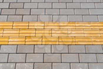 Tactile paving for blind handicap on tiles pathway, walkway for blindness people.