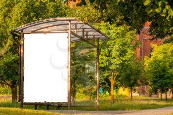 Blank white mockup of bus stop vertical billboard in front of nature background