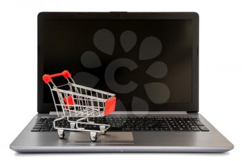 Shopping Online Concept : mini shopping cart on laptop, isolated on white background