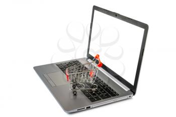 Shopping Online Concept : mini shopping cart on laptop computer with blank screen. Isolated on white background.