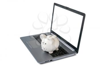 Piggy bank with laptop which means make money online or internet business concepts. Blank screen, copy space.