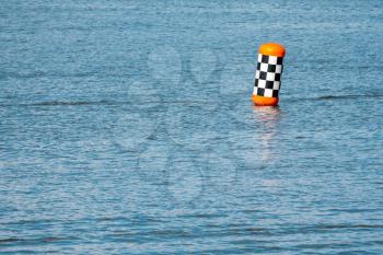 Red buoy in a lake ready for the powerboats race