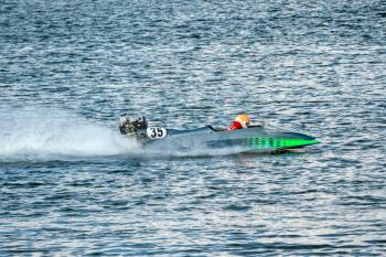 Powerboat with number 35 go fast along the lake at powerboat racing