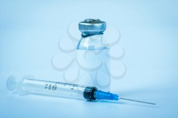 A bottle of medicine or vaccine and medical syringe  for injection