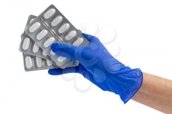Doctor or scientist hand in blue nitrile glove holds  capsule packs . Healthcare concept.