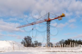 Construction site with a tower crane. Construction of multi-storey building in winter