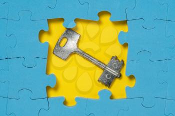 Jigsaw Puzzle with Metal Key, business concept, solution key