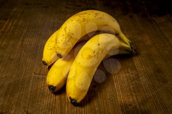 Bunch of Yellow Bananas on Grunge Wooden Background. Close up View