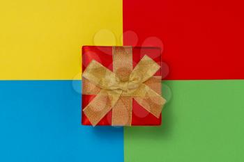 Luxury gift box on colored paper background. Holiday concept.