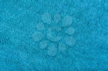 Blue plush fabric background. Blue towel cloth close-up.