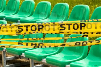 Protective stop tape prevents spectators from entering stadium during competition without spectators during Coronavirus epidemic. Concept of social distancing and covid 19 lockdown easing. 