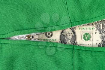 Closeup view of green sweatshirt with zipper and one dollar as background